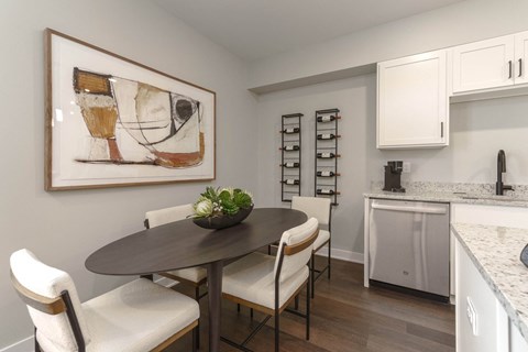 a kitchen and dining room with a table and chairs